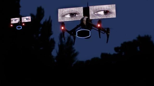 A drone carrying digital images of two human eyes flying at dusk.